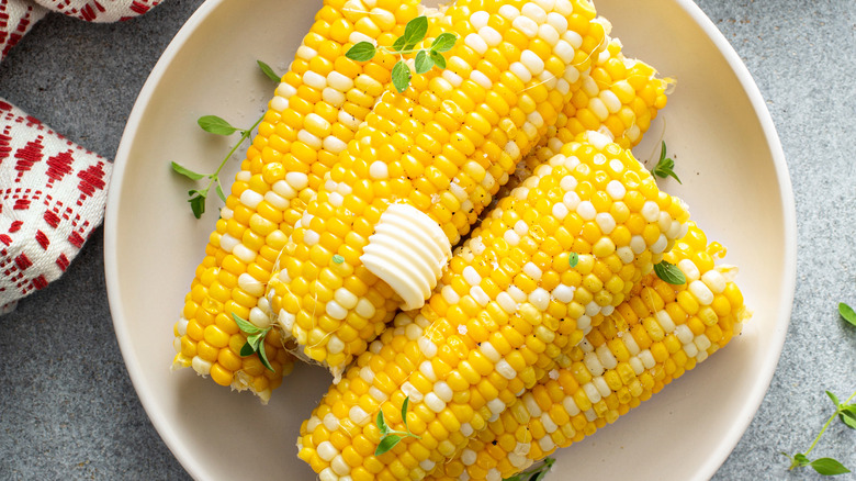 corn on the cob in bowl with butter