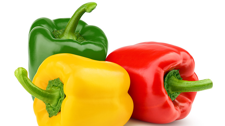 A pile of red, yellow, and green peppers