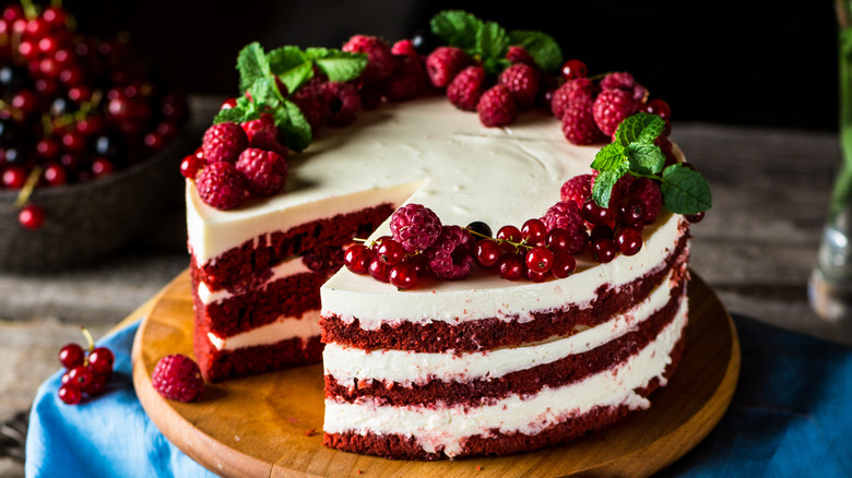 Laired red velvet cake with berries on top