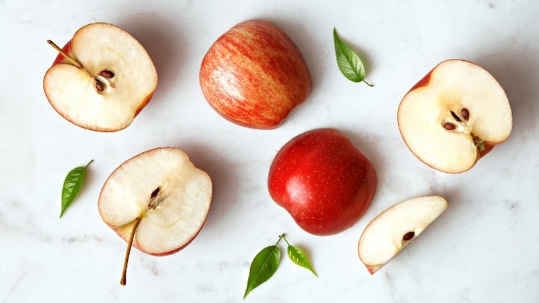 Sliced apples on marbled background