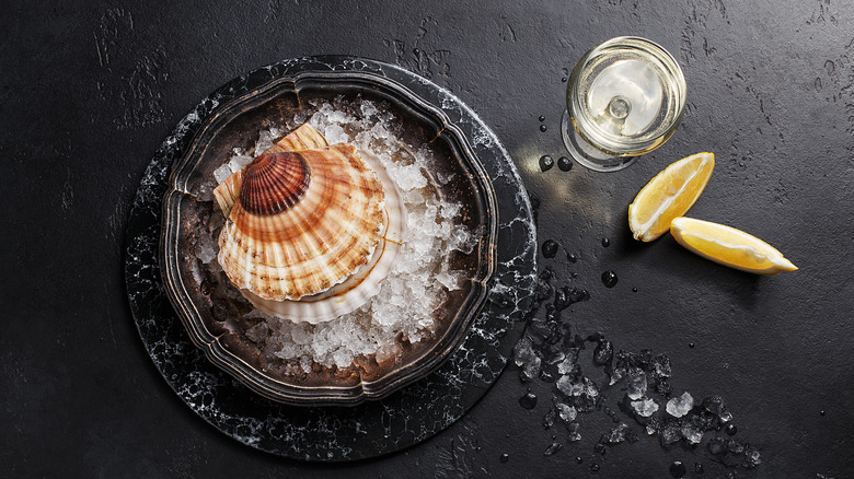 Top down view of scallop shell and wine glass