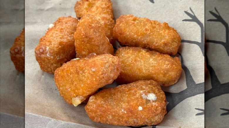 close up of Burger King Jalapeño Cheddar Bites sitting on a paper