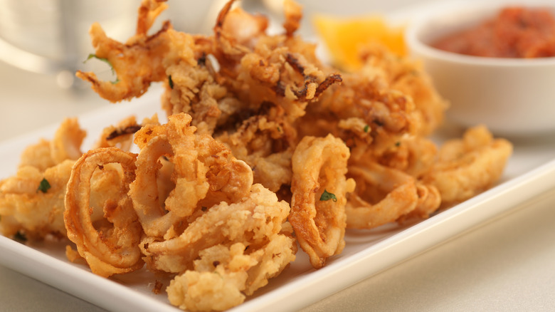 fried calamari on plate with sauce