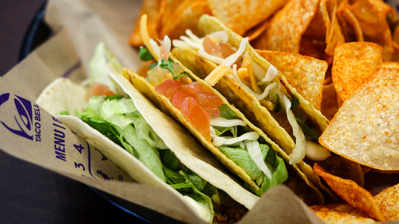 Close up of Taco Bell tacos with Doritos in background