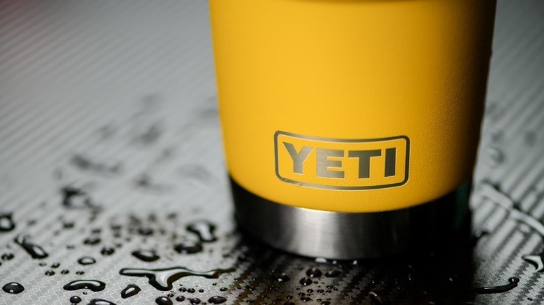 Yellow Yeti Rambler on a wet surface