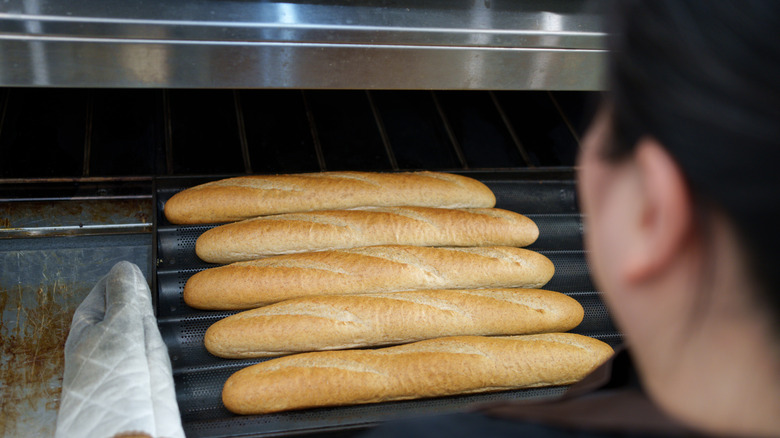 Person Toasting Sub Rolls