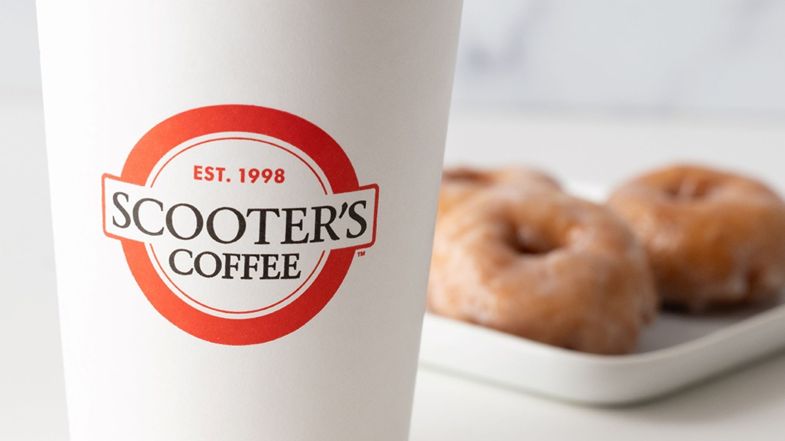 The Adorable Reason Scooter's Coffee Cups Have A Smiley Sticker