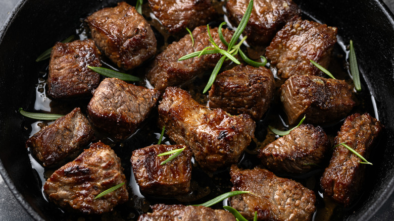 steak tips cooking in a pan