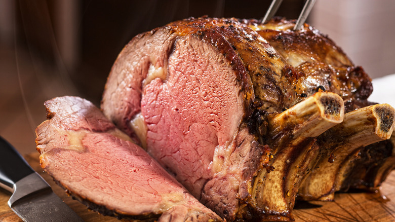 Sliced bone-in prime rib roast steaming