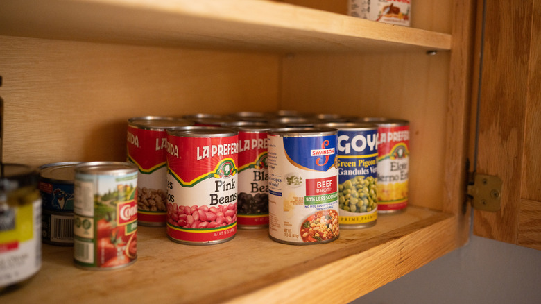 Canned food on pantry shelf
