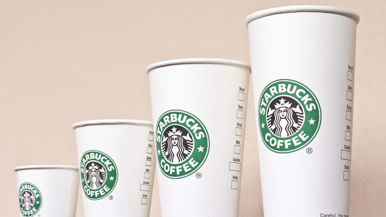 Row of differently sized Starbucks cups