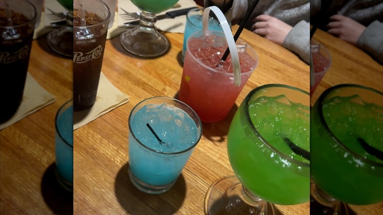 A selection of colorful drinks sitting on a table at an Applebee's location