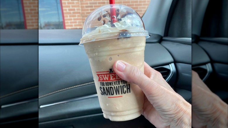 Hand holding Arby's classic coffee and chocolate Jamocha Shake