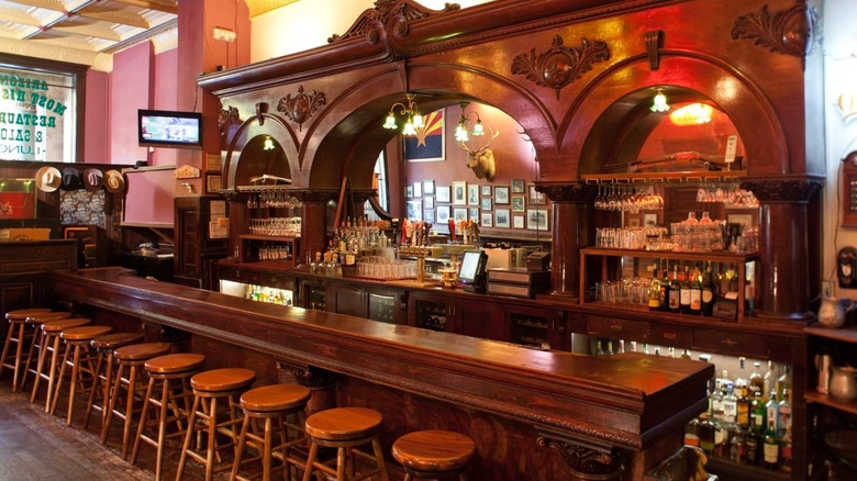 The Palace interior with framed photos, gun