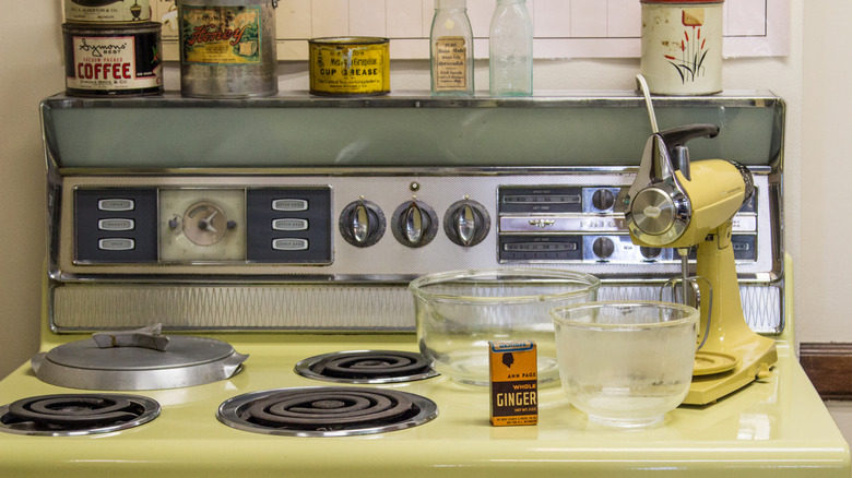 1950s cooker with old fashioned mixer on the stovetop and vintage food tins and bottles