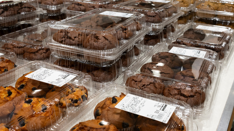 Plastic boxes of blueberry and double chocolate Costco Kirkland Signature muffins on white counter