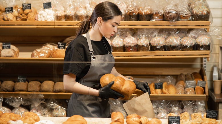 Bakery worker holding bread