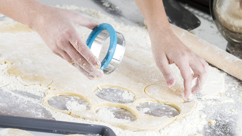 chef using circular pastry cutter 