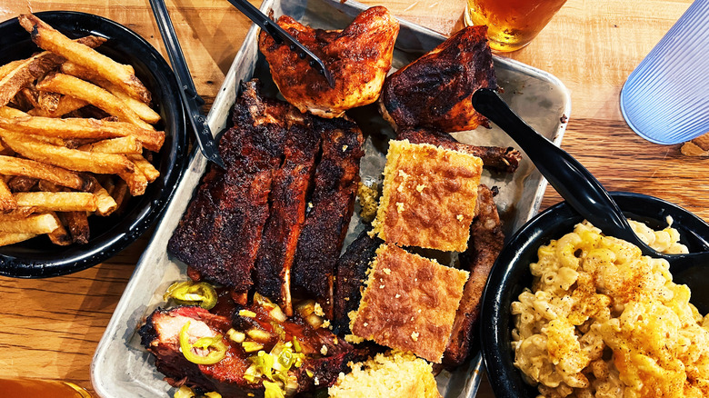barbecue plate with chicken, ribs, cornbread, macaroni and cheese, and fries