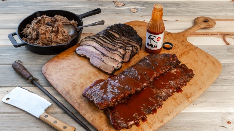4 Rivers Smokehouse smoked ribs, brisket, and pulled pork with BBQ sauce.