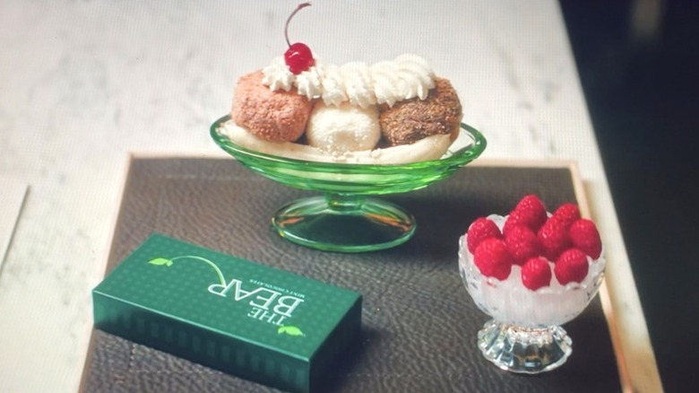 A banana sundae, raspberries in a dish, and a green box of mints in "The Bear" Season 5