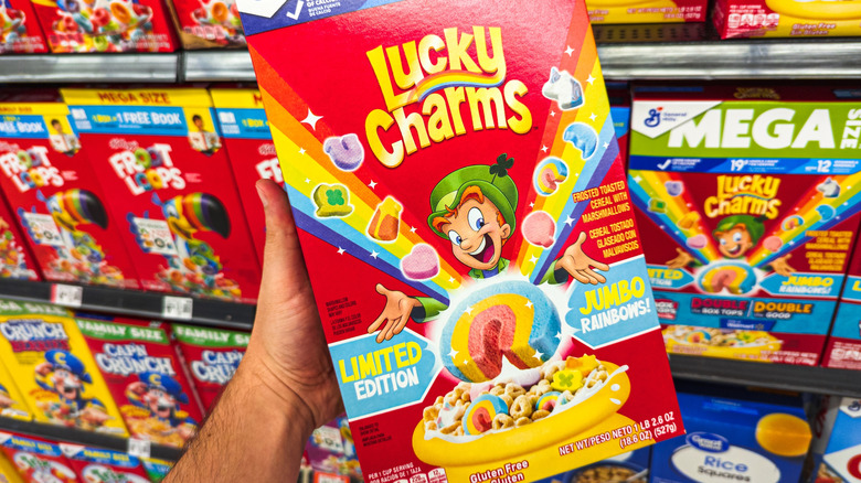 Person holding Lucky Charms box.