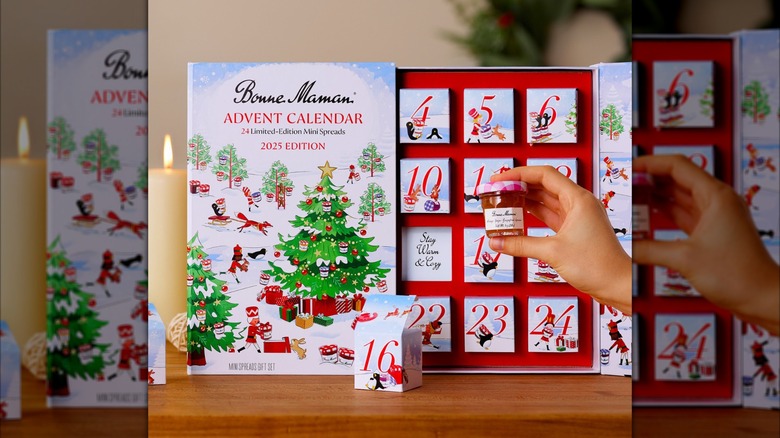 Bonne Maman's advent calendar opened with a hand holding a jam jar