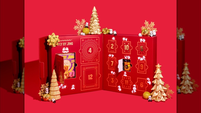 red box opened to reveal gold lettering and products