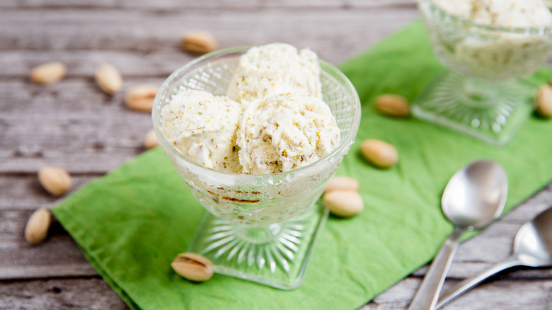 Pistachio ice cream served on table