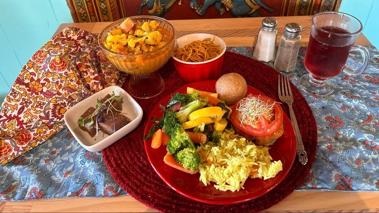 Assorted Indian dishes on table with colorful cloths