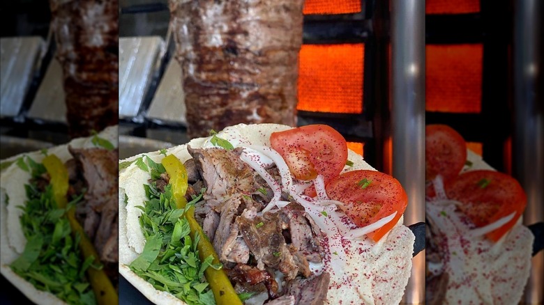 Fresh veg and sliced meat with doner kebab blurred in background