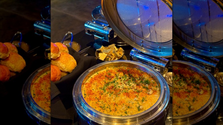 Pasta in warmer on buffet with basket of rolls