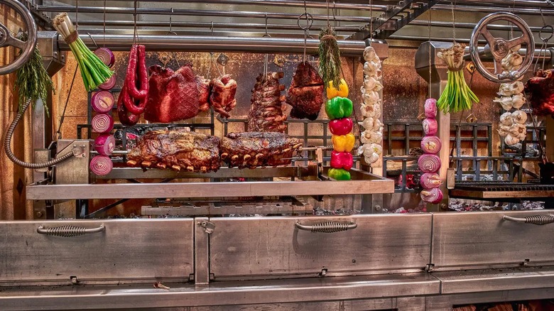 Assortment of meats and vegetables in grill area