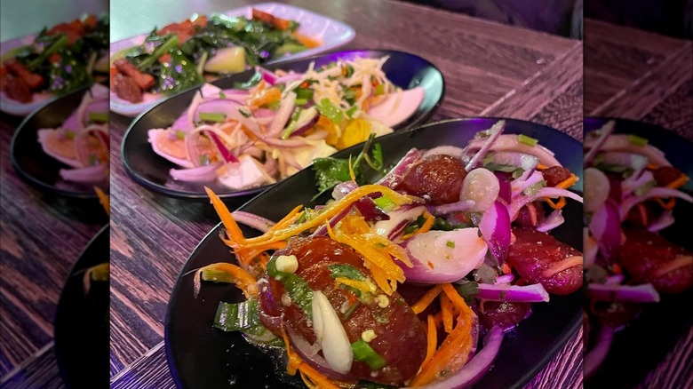 Assortment of Thai dishes on wooden table
