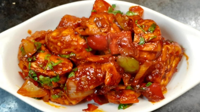 Hot chili and chicken dish on white plate