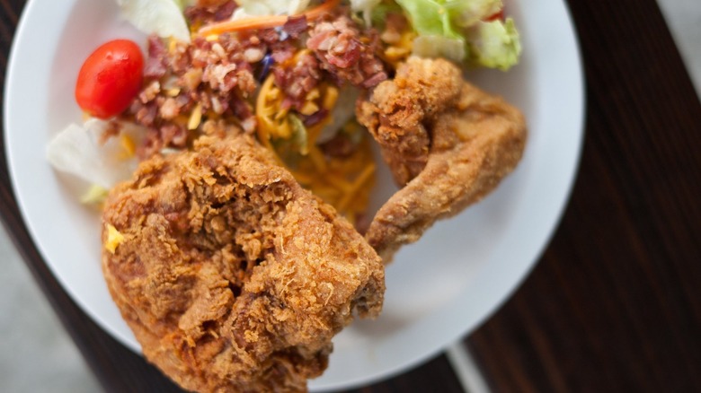 Plate of fried chicken with salad