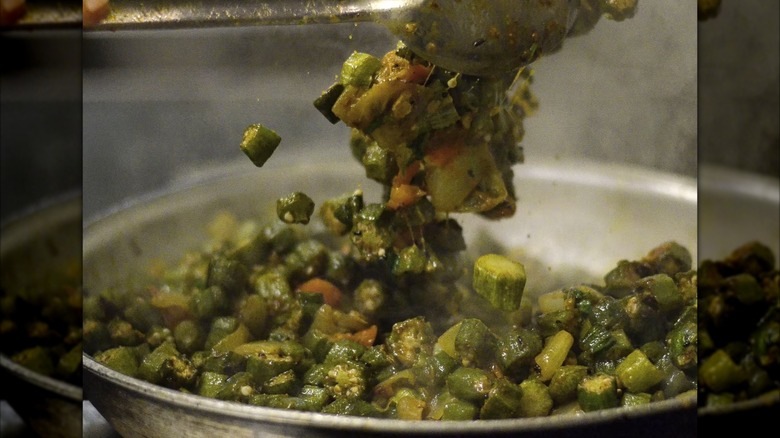 Okra dish being tossed in silver pan