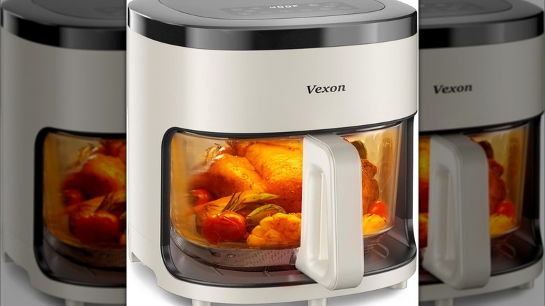 A close up of the Vexon 6-IN-1 4.5QT Glass Air Fryer showing a chicken cooking inside