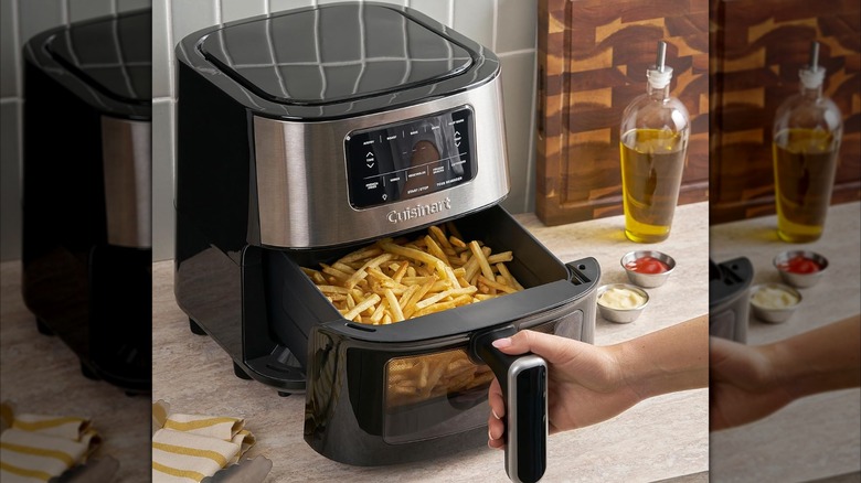 The Cuisinart 6-Quart Basket Large Air Fryer on a kitchen countertop cooking a basket of fries
