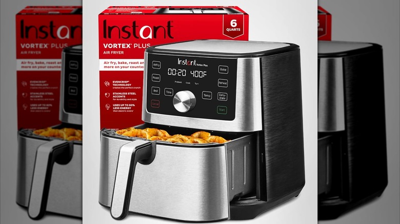 The Instant Pot Vortex Plus 6QT XL Air Fryer on a plain background with its box