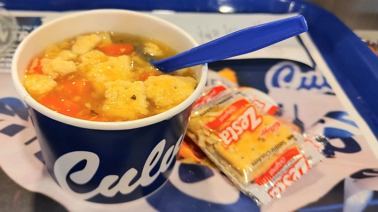 Culver's chicken noodle soup with saltine crackers on a tray