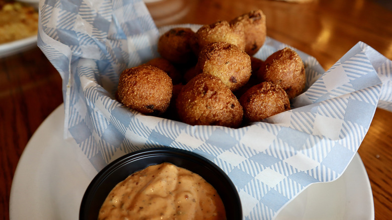 hushpuppies and sauce in basket