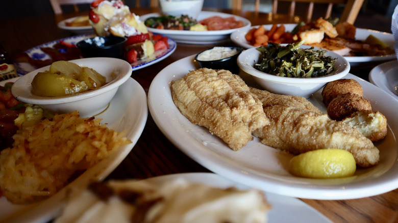 table of food featuring fish, fried apples, French toast