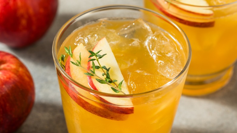 Close-up of a bourbon drink garnished with apple slices