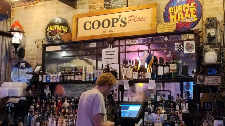 A bartender at work behind the bar at Coop's place.