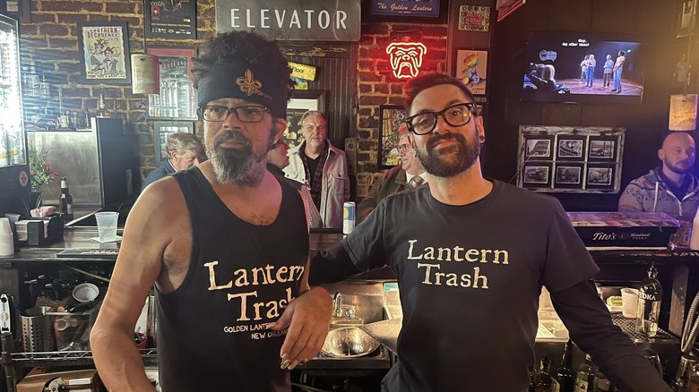Two bartenders of the Golden Lantern Bar standing behind the bar.