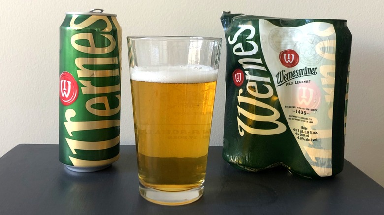 Glass of Wernesgruner with the cans in background