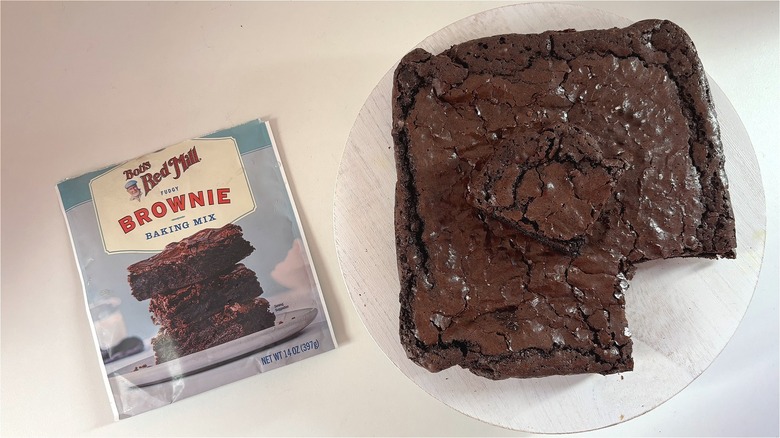Bob's Red Mill Fudgy Brownie Mix package next to baked brownies