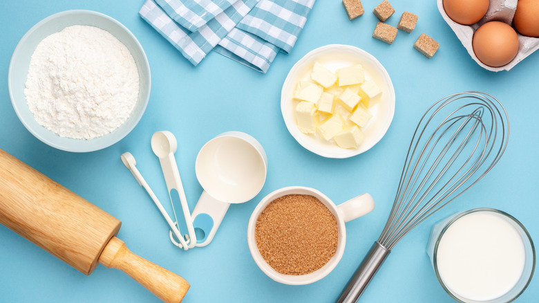 Variety of baking supplies on blue surface