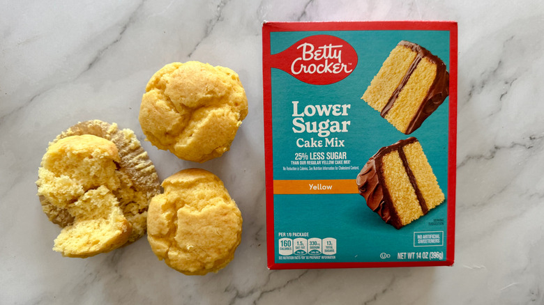 Betty Crocker lower-sugar cake mix box with cupcakes on marble surface